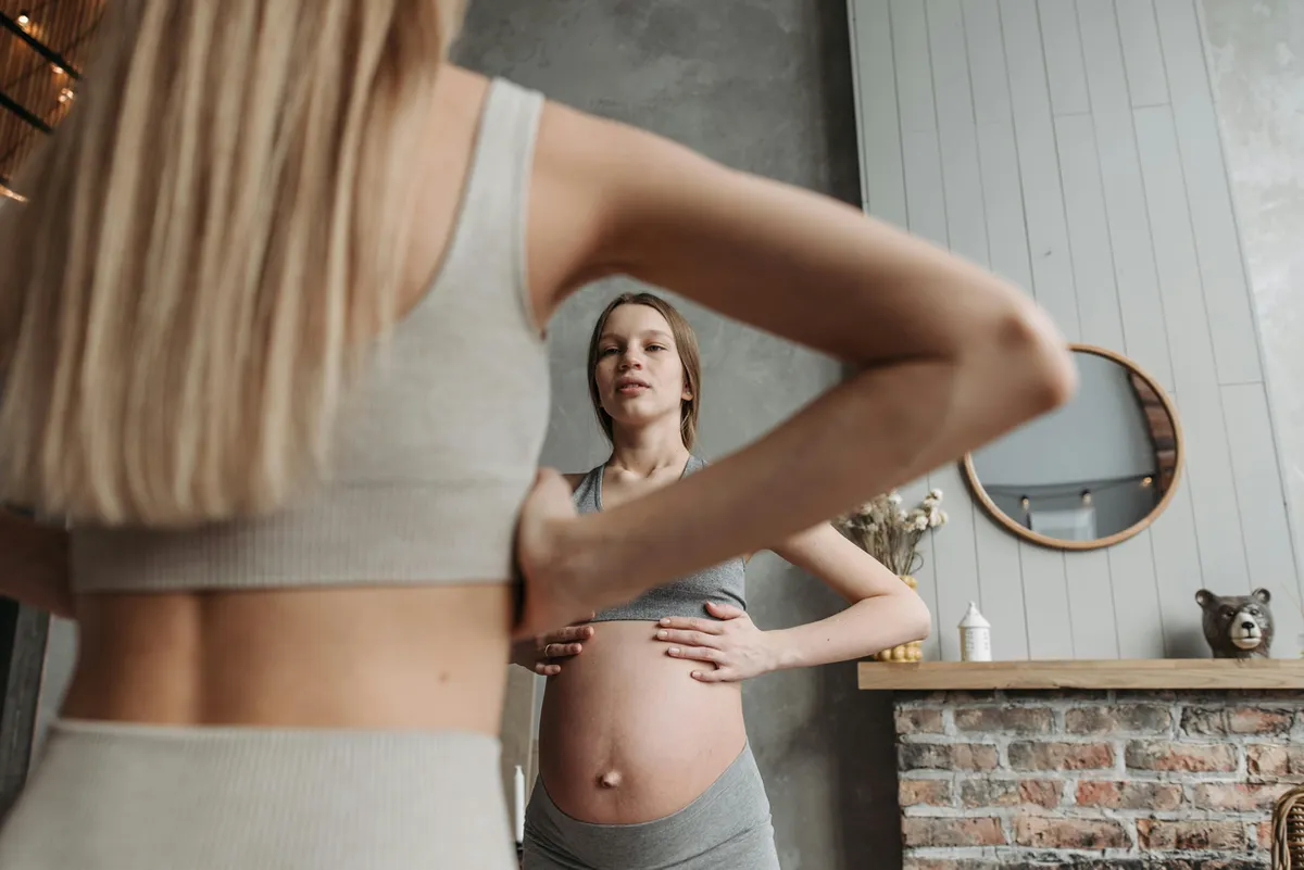 A pregnant woman in a calm yoga stretch