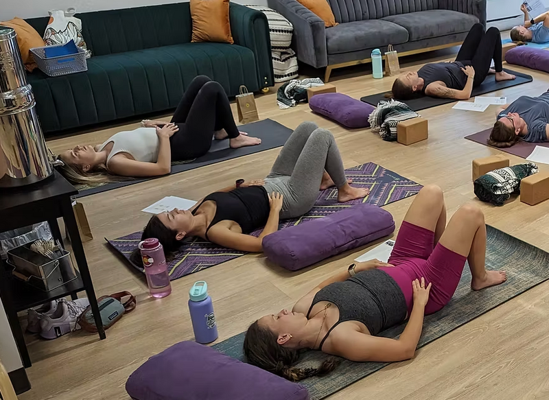 Pregnant women practicing yoga together on mats